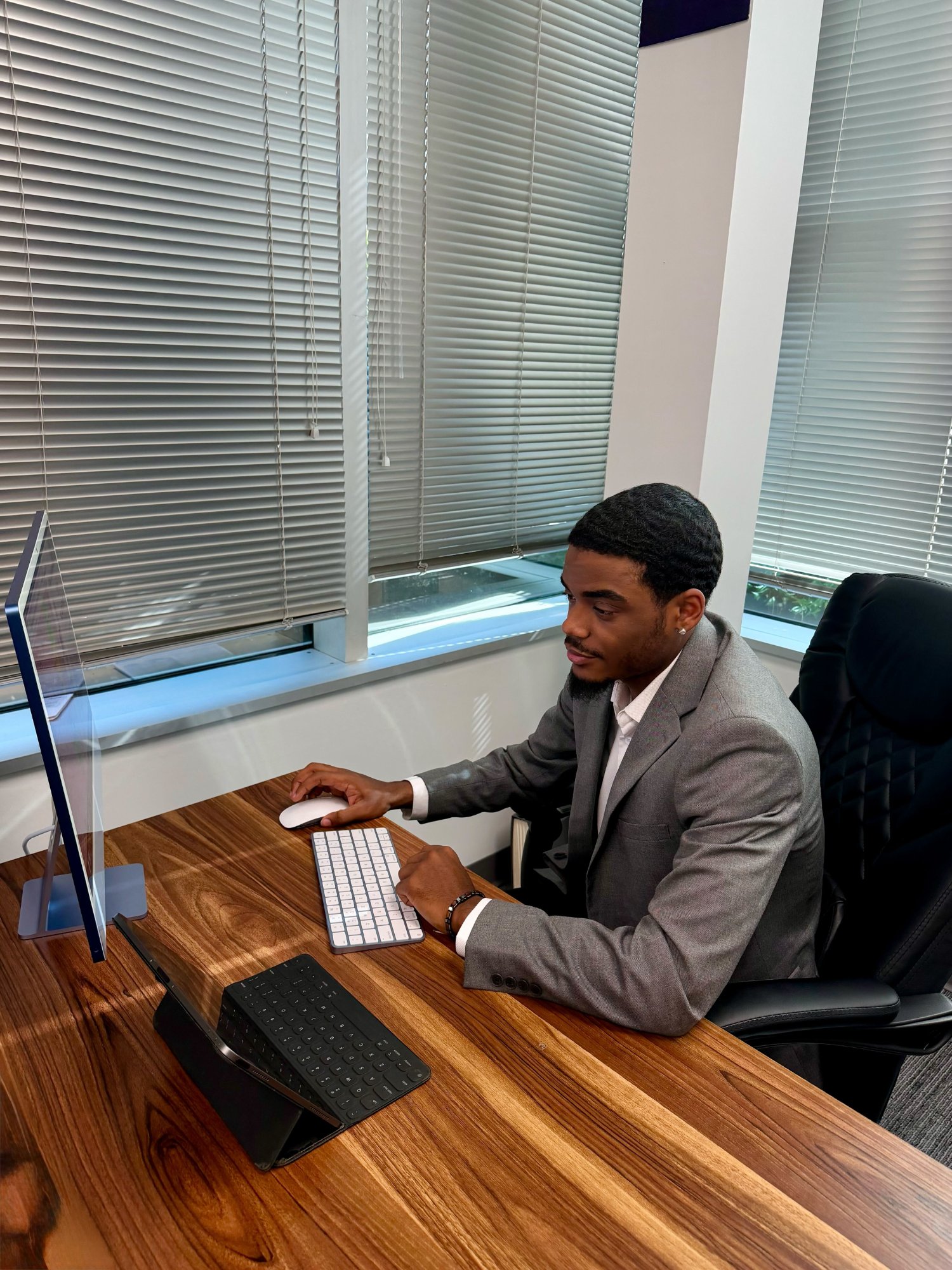 Fifth Leaf Strategies professional in a tan suit standing confidently in front of corporate buildings